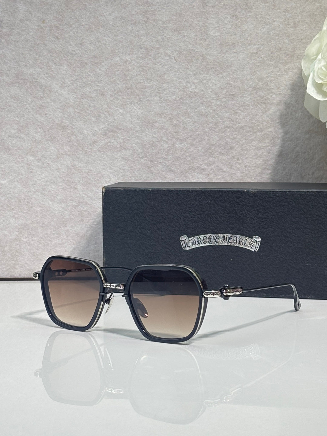 Gold-and-blue square sunglasses with dark lenses and clear temple, ornate hinge