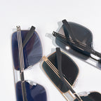 Prada sunglasses pair with dark lenses and gold-tone frames, stacked view