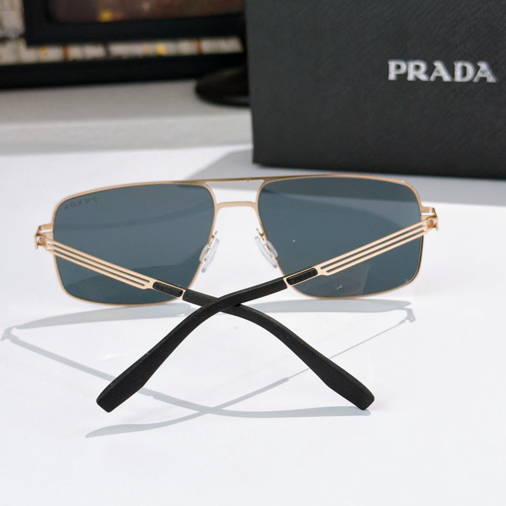 Prada sunglasses front view with gold-tone frame and blue-tinted lenses