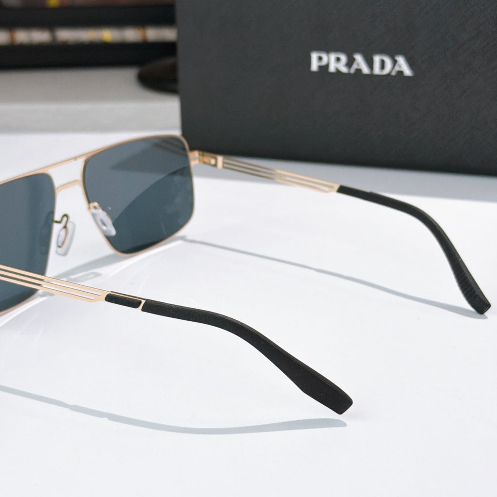 Prada sunglasses side view with gold-tone metal arms and dark lens