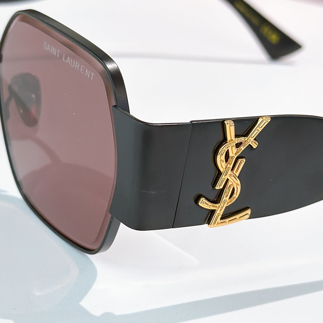 Black sunglasses with rosy tinted lenses and gold YSL-style side logo