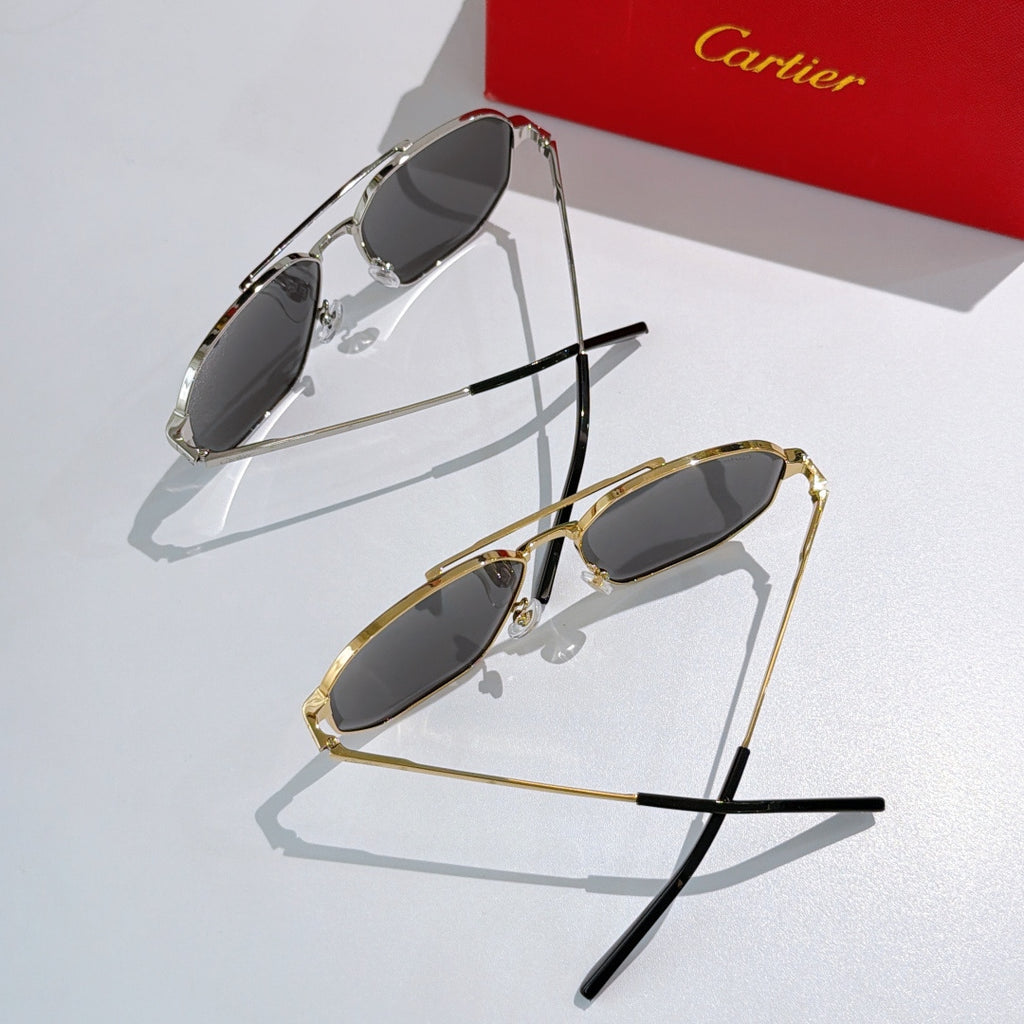 Two sunglasses with gray lenses: one silver-tone and one gold-tone, angled top views