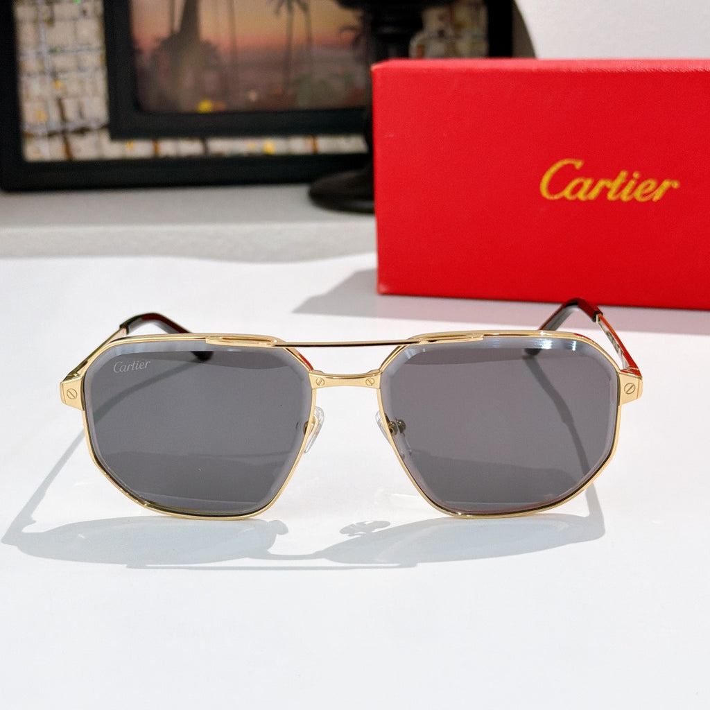 Sunglasses with gold-tone frame and dark gray lenses, rounded geometric shape