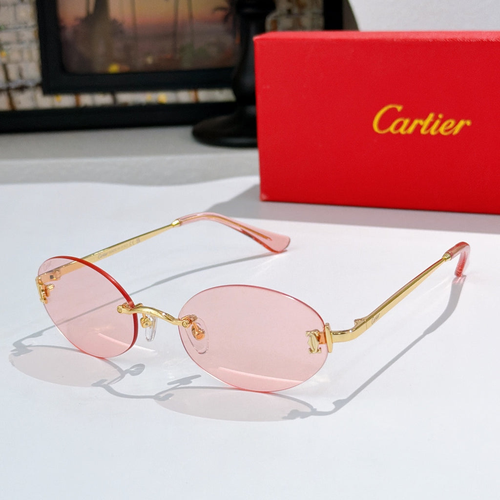 Cartier round sunglasses with gold frame and light pink tinted lenses with orange temples