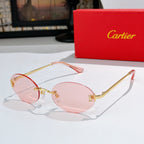 Cartier round sunglasses with gold frame and light pink tinted lenses with orange temples