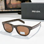 Prada sunglasses with brown frames and amber-tinted lenses