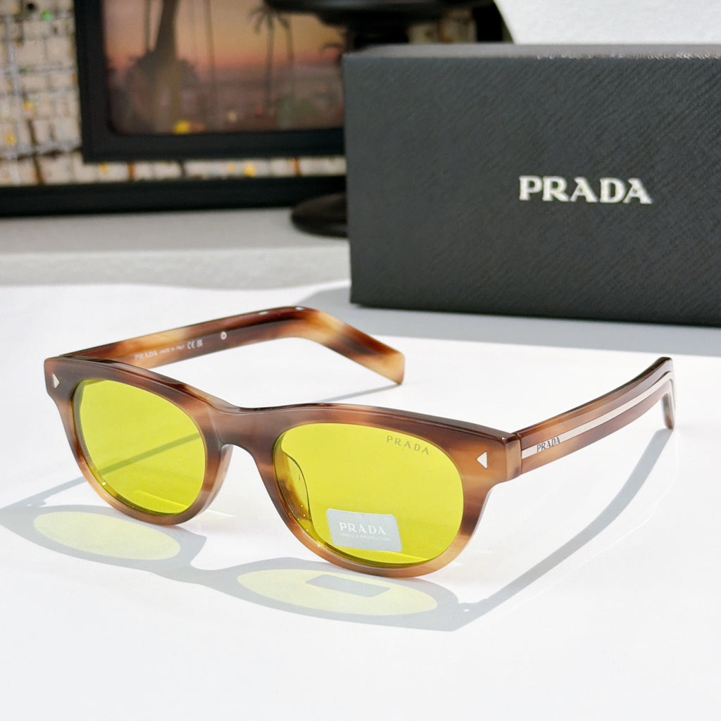 Prada sunglasses with orange-brown frames and yellow-green lenses