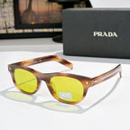 Prada sunglasses with orange-brown frames and yellow-green lenses