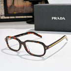 Prada eyeglasses with tortoiseshell frames and clear lenses