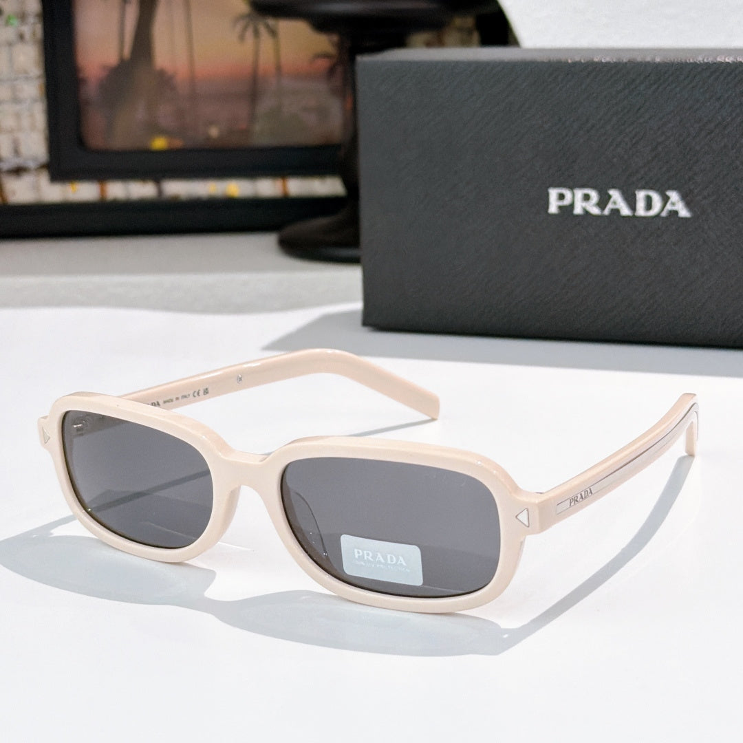 Prada sunglasses with cream frames and gray-tinted lenses