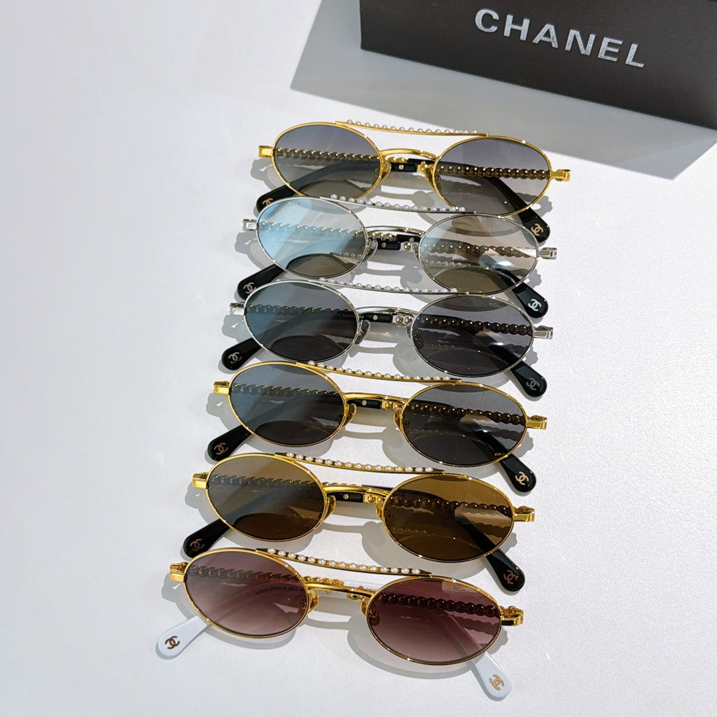Stack of round sunglasses with mixed frames and lens colors, pearl temple detailing