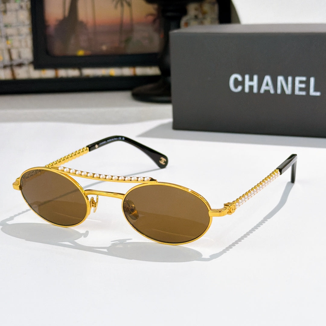 Gold round sunglasses with brown lenses, pearl chain detail on temples