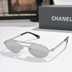 Silver round sunglasses with light lenses, rhinestone chain detail on temples