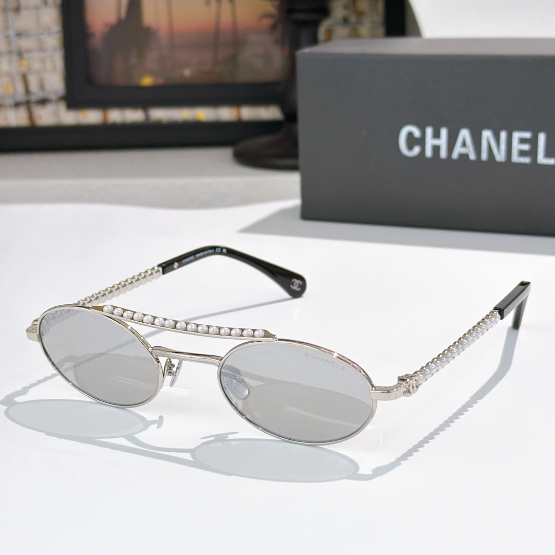 Silver round sunglasses with light lenses, rhinestone chain detail on temples
