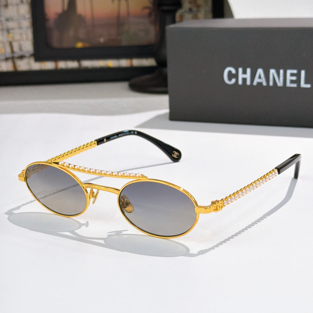 Gold round sunglasses with dark lenses, pearl chain detail on temples