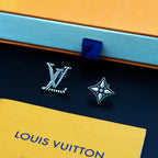 Louis Vuitton accessories: silver stud earrings on navy card with blue ribbon