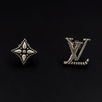 Louis Vuitton accessories: silver star and LV monogram stud earrings on dark background