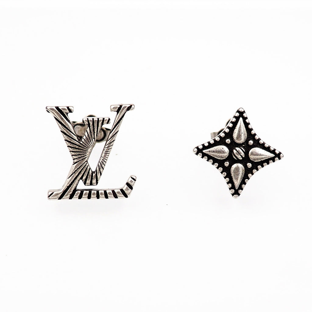Louis Vuitton accessories: silver star and LV monogram stud earrings, close view