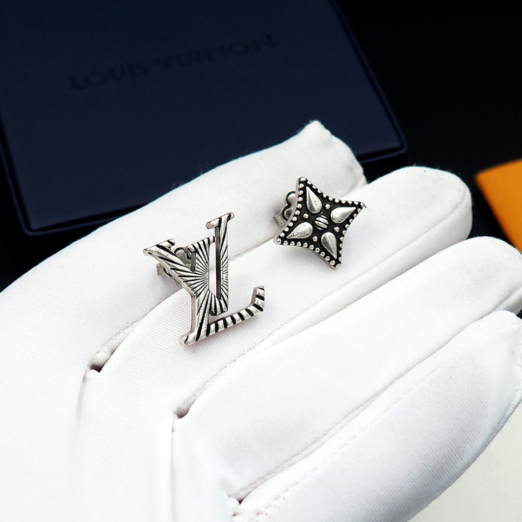 Louis Vuitton accessories: silver stud earrings on white cloth pouch, star and LV