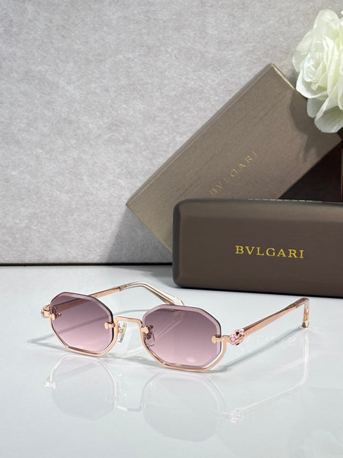 Sunglasses with pink tinted lenses and rose-gold metal frame, gold-tone accents