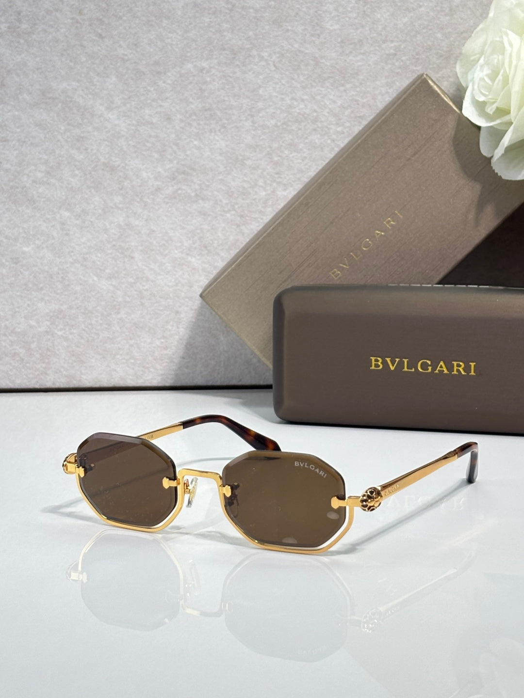 Sunglasses with brown tinted lenses and gold metal frame, dark brown acetate accents