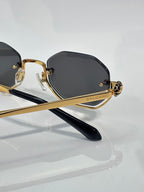 Gold and black octagonal sunglasses with dark lenses