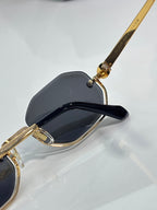 Octagonal sunglasses with black temple and gold hinge detail