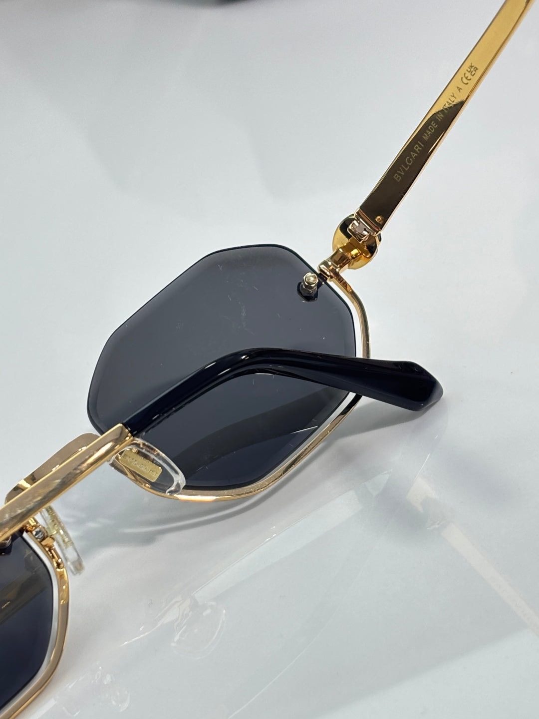 Octagonal sunglasses with black temple and gold hinge detail