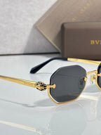 Gold-tone octagonal sunglasses with dark lenses and black temple arms