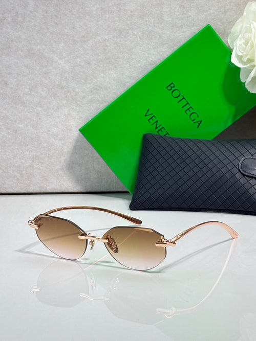 Bottega Veneta sunglasses with amber lenses and rose-gold frame, slim metal arms