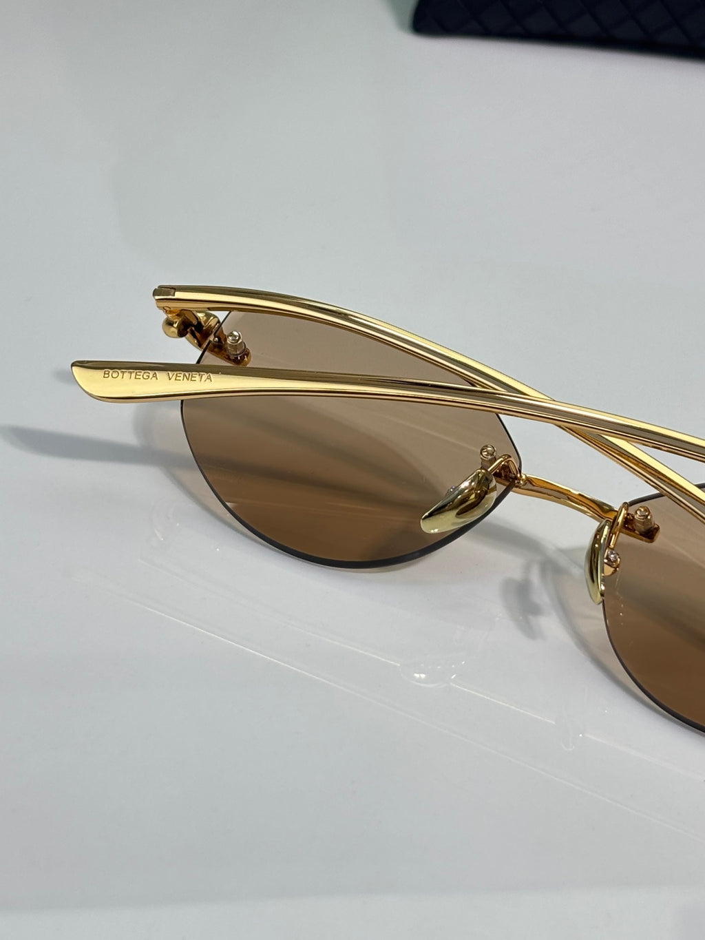 Bottega Veneta gold-tone glasses with brown lenses, temple bar view