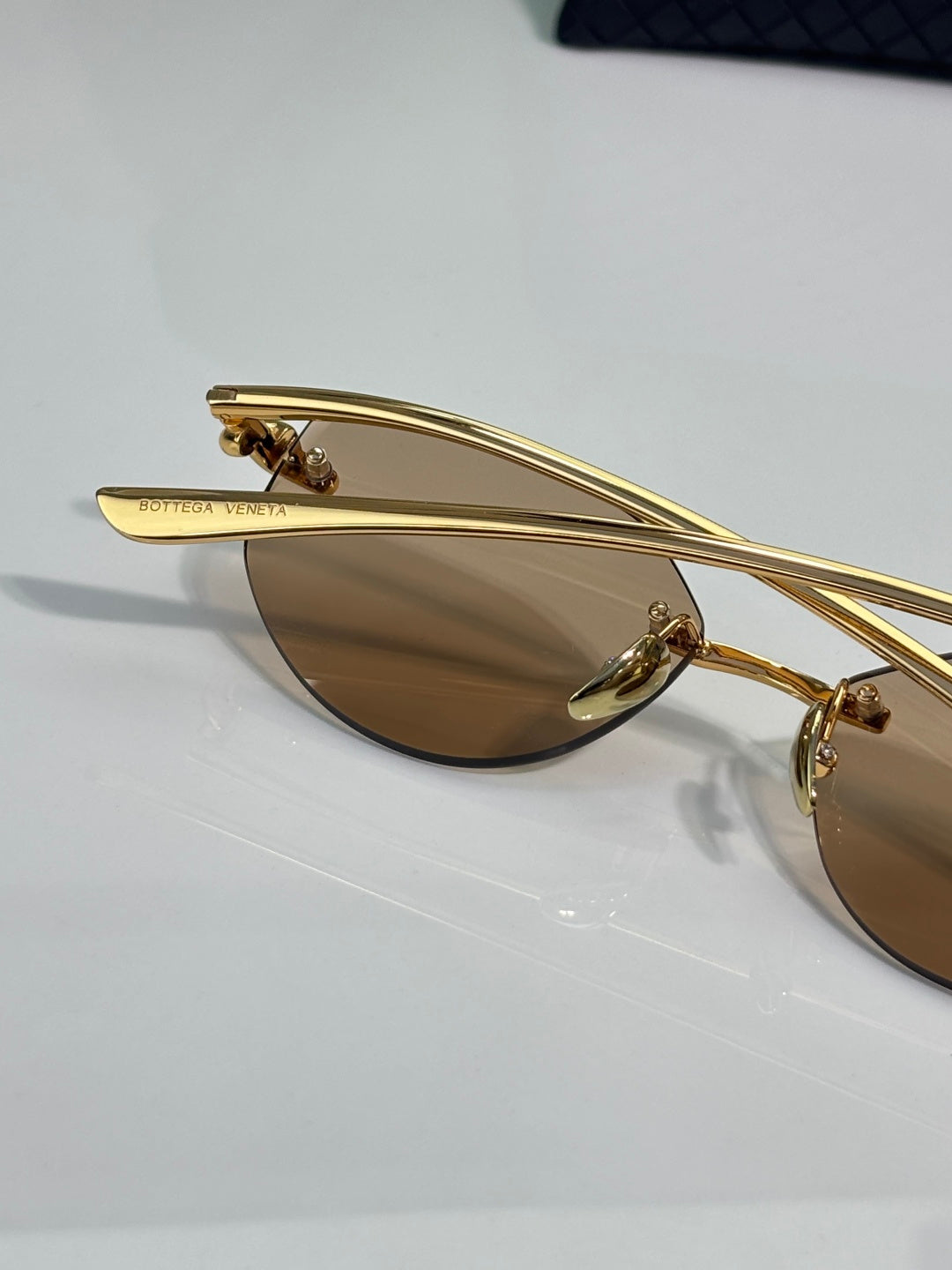 Bottega Veneta gold-tone glasses with brown lenses, temple bar view