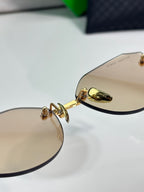 Bottega Veneta gold-tone glasses with brown lenses, hinge detail