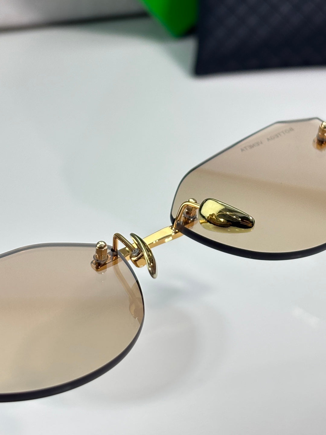 Bottega Veneta gold-tone glasses with brown lenses, hinge detail