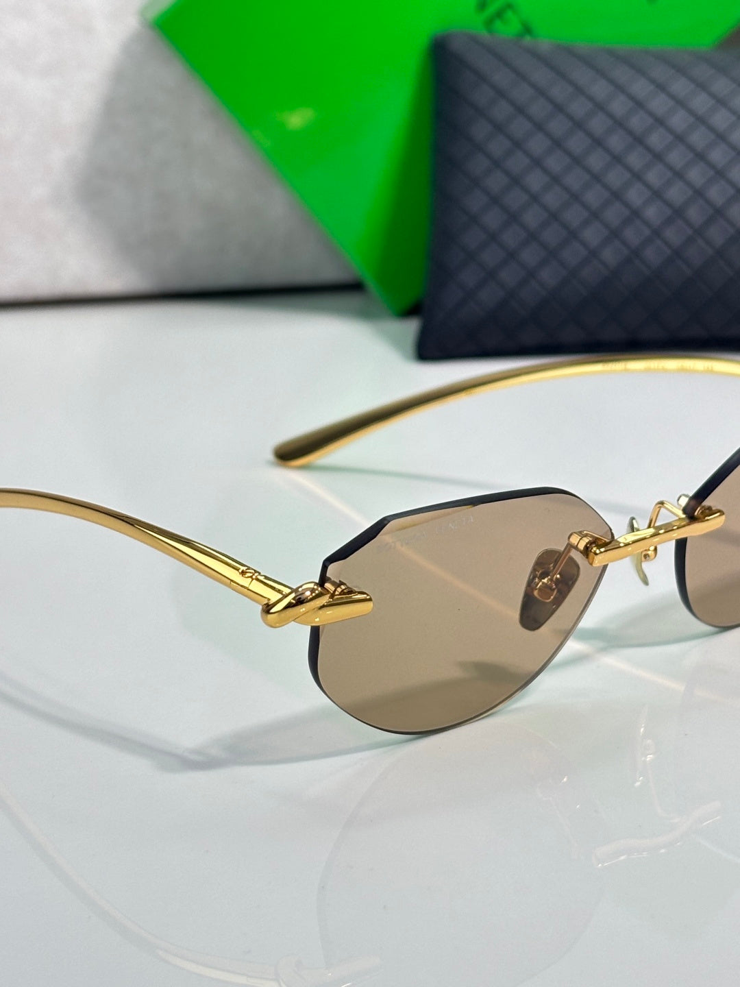 Bottega Veneta gold-tone glasses with brown lenses, side view