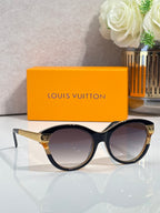 Sunglasses with black round frames, gold-tone temple accents, and dark tinted lenses