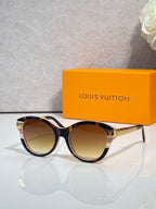 Louis Vuitton sunglasses with dark round frames and gold-tone temple details