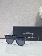 Chrome glasses with dark navy square frames and tinted lenses, metal hinge detail