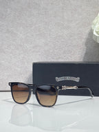 Chrome glasses with dark frames, brown-tinted lenses and small metal emblem on temple