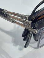 Chrome glasses close-up of chrome temples with ornate metal hinge and rivets
