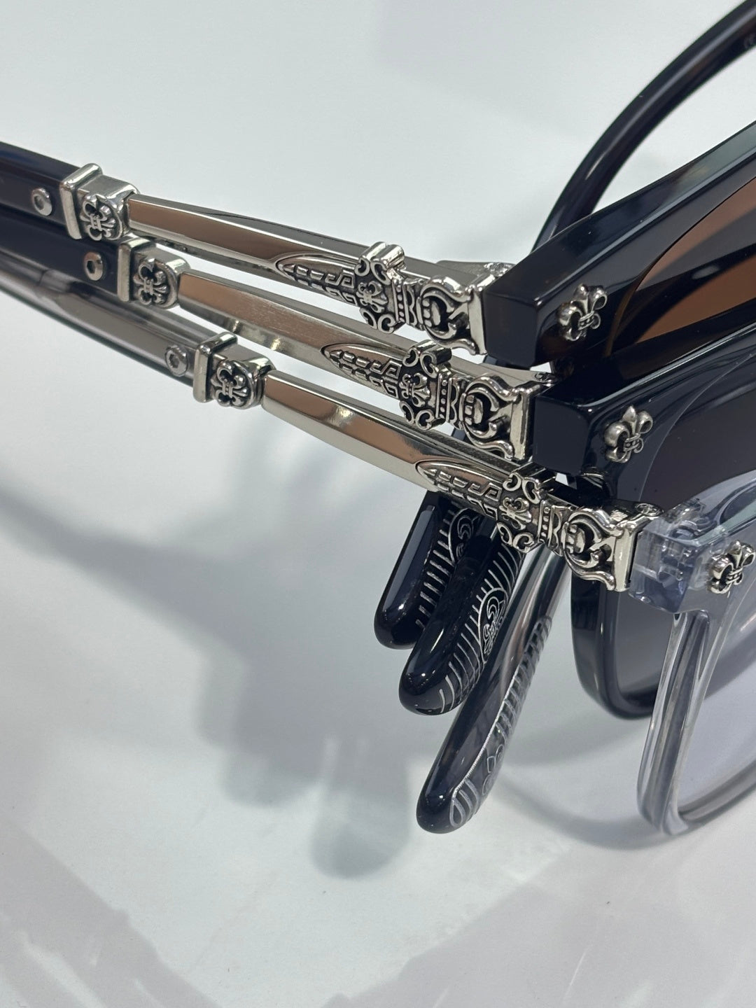 Chrome glasses close-up of chrome temples with ornate metal hinge and rivets
