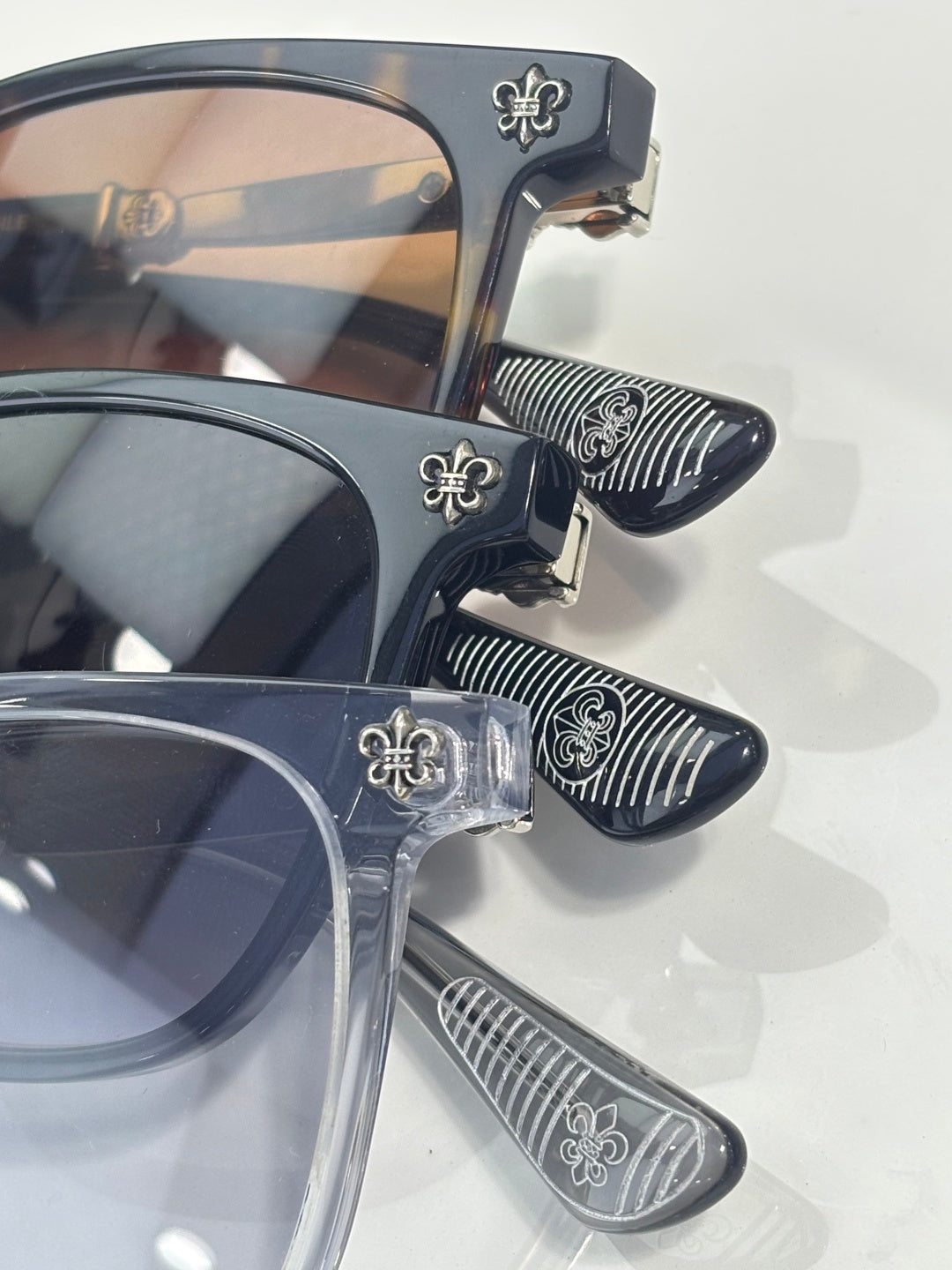 Chrome glasses close-up of dark nose pad and striped temple tips, chrome frame hardware