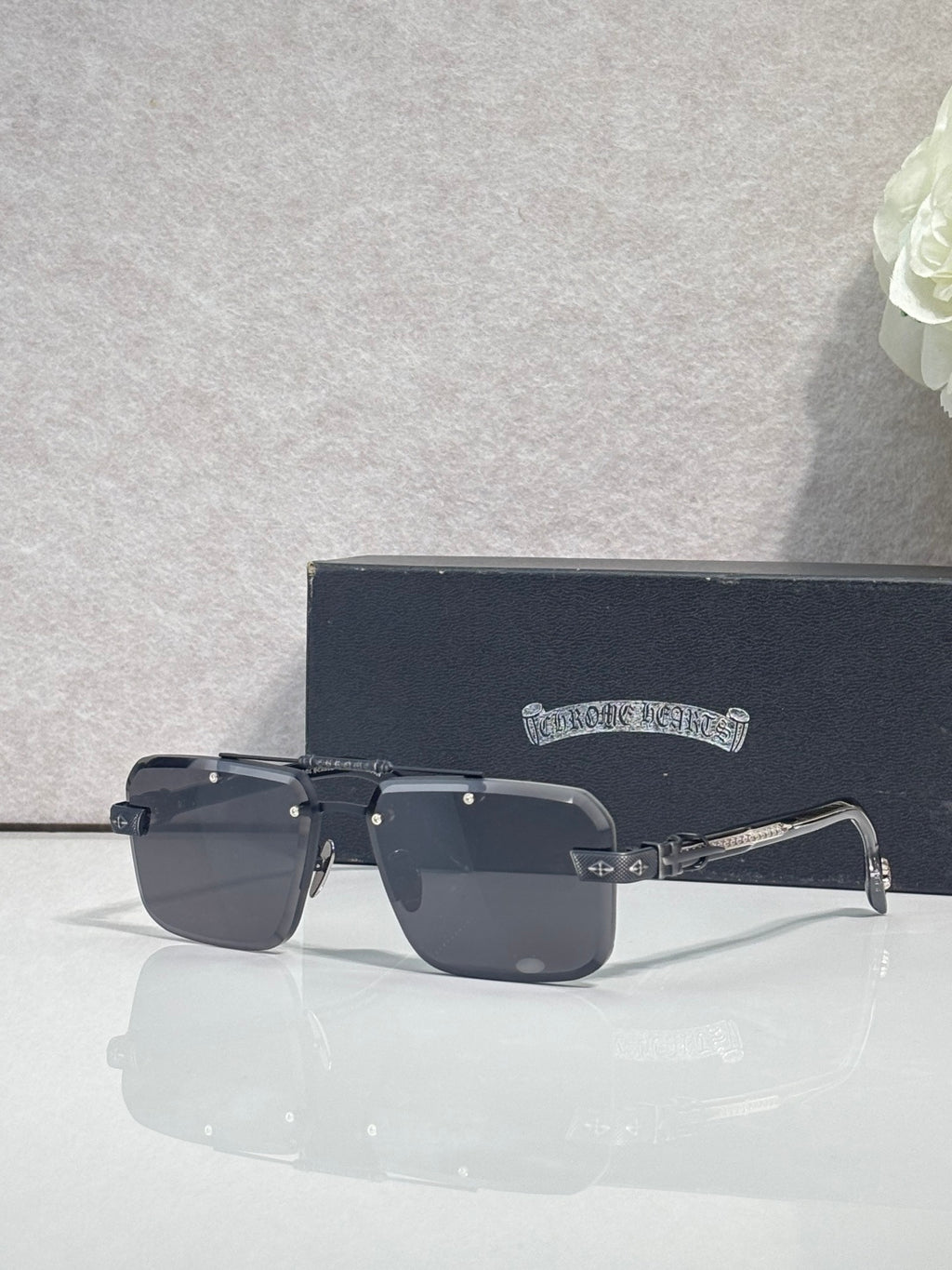 Black rectangular sunglasses with tinted lenses and chrome temple arms