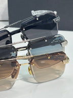Stacked sunglasses view with black frames, tinted lenses, and gold-tone details