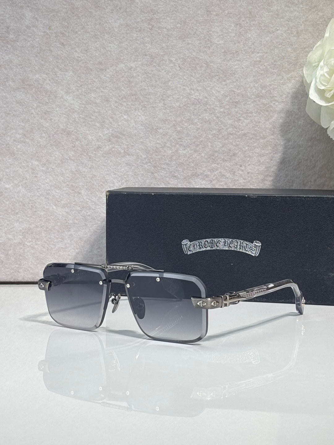 Black rectangular sunglasses with dark tinted lenses and slim chrome temples