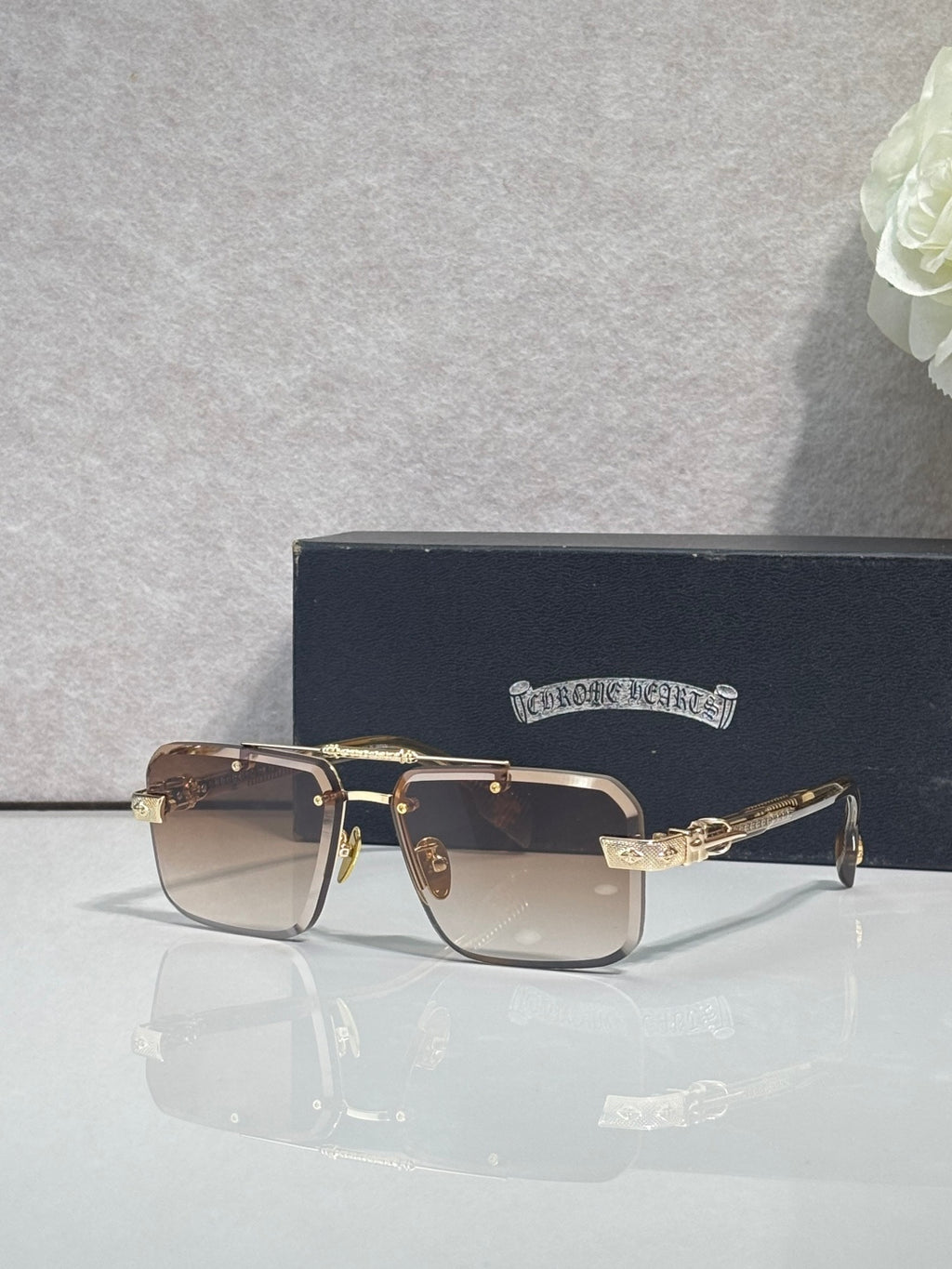 Two-tone rectangular sunglasses with dark lenses and gold-tone metal frame