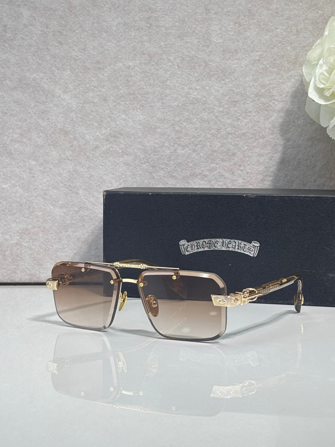 Two-tone rectangular sunglasses with dark lenses and gold-tone metal frame