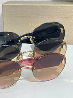 Pair of sunglasses in layered view with blue, pink, and brown lenses