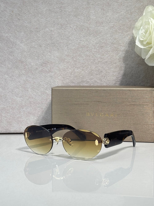 Sunglasses with dark lenses, black temples, and gold-tone embellished bridge