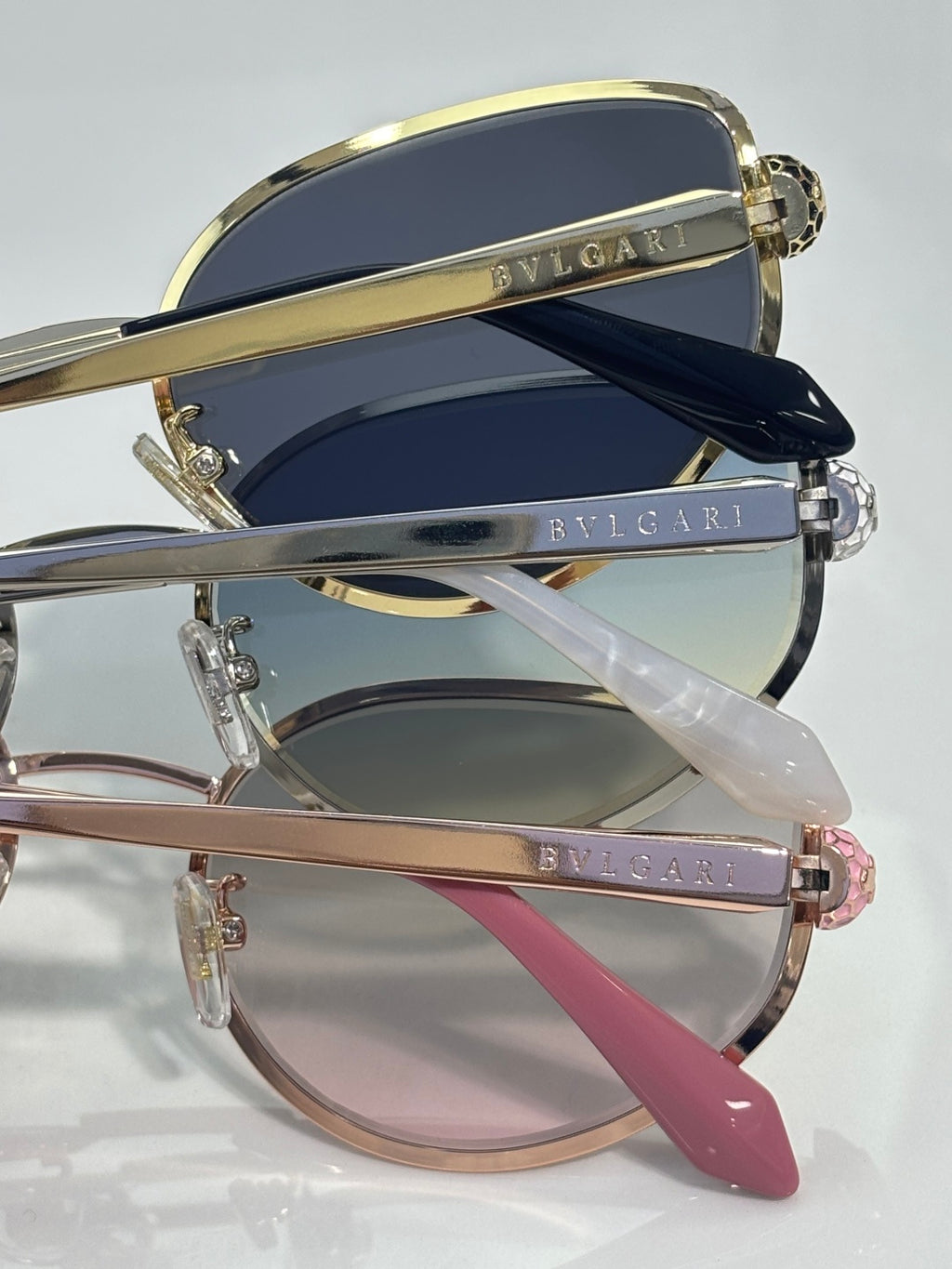 Stack of Bvlgari sunglasses with mixed frames and tinted lenses